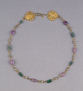 Gold necklace strung with pearls, amethyst and green glass beads with two gold openwork roundels by Byzantine